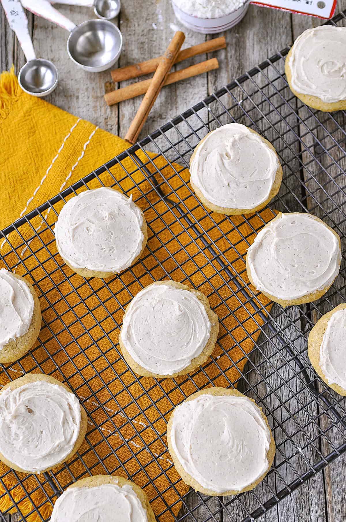 overhead shot of frosted pumpkin sugar cookies on a baking rack