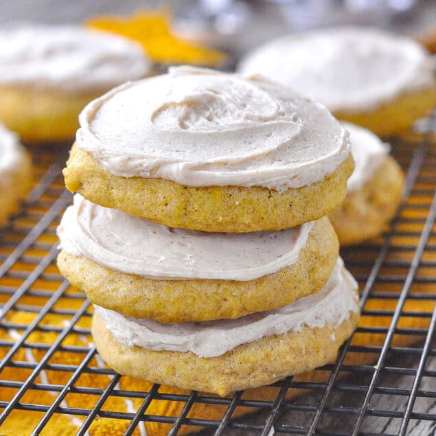 3 pumpkin sugar cookies stacked on top of each other