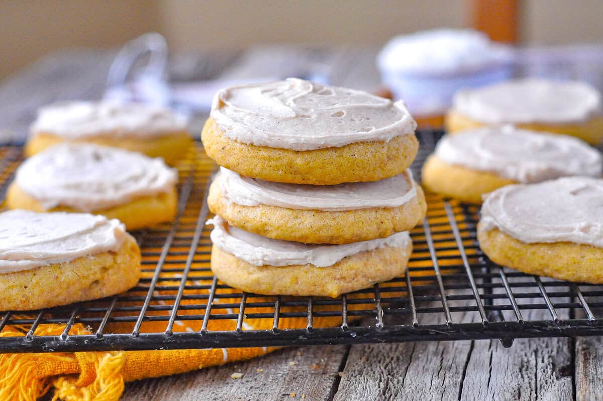 stack of frosted pumpkin sugar cookies
