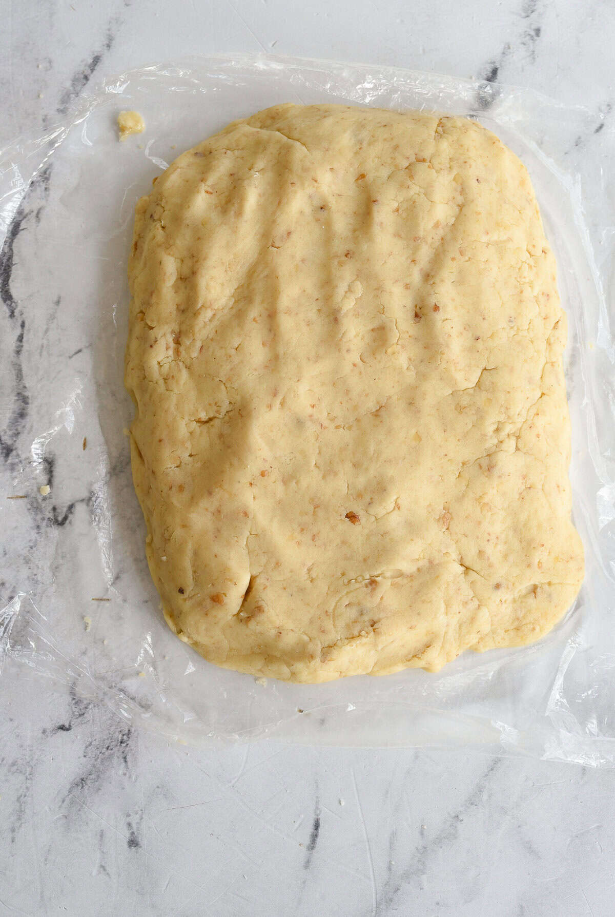 disc of cookie dough on plastic wrap