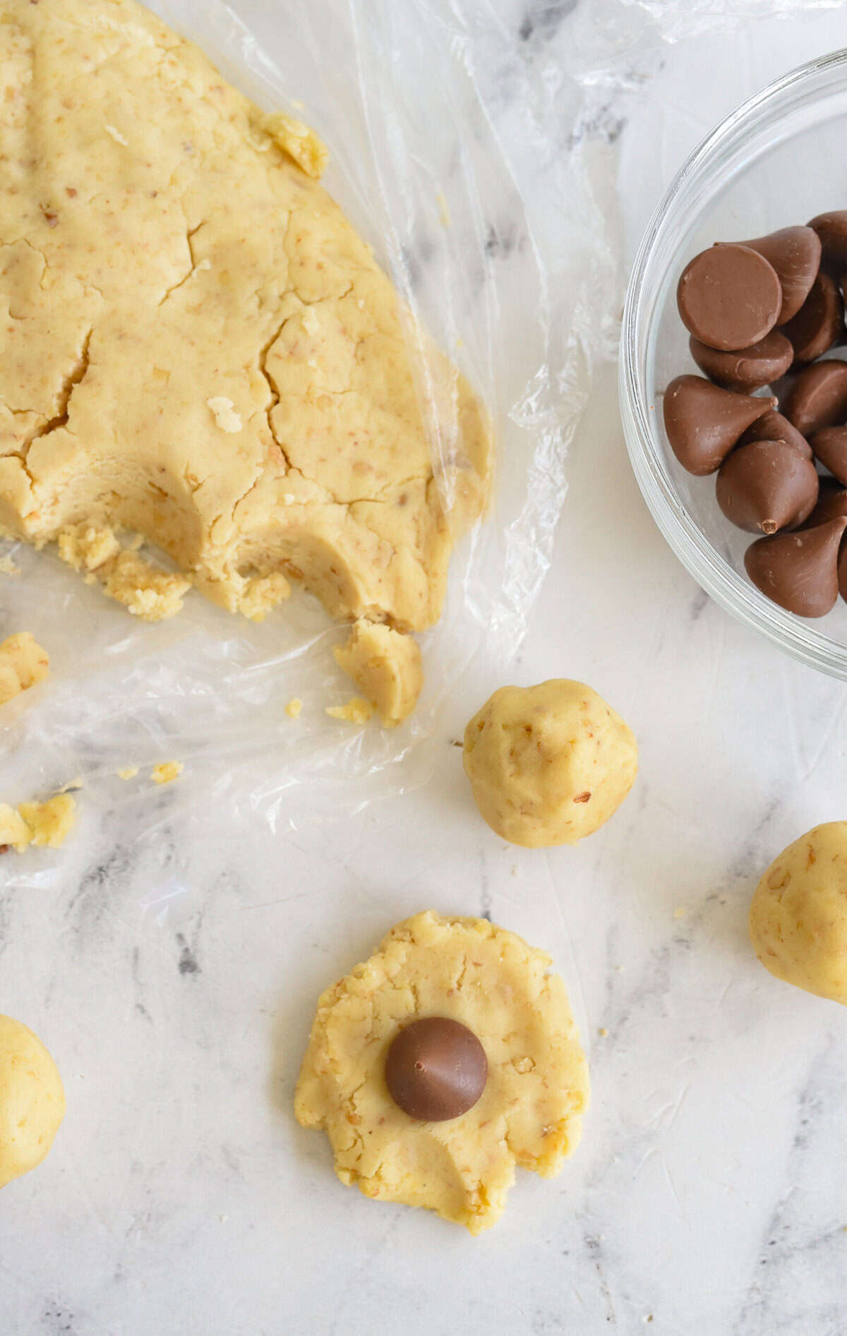 scooping dough and utting hershey kisson it