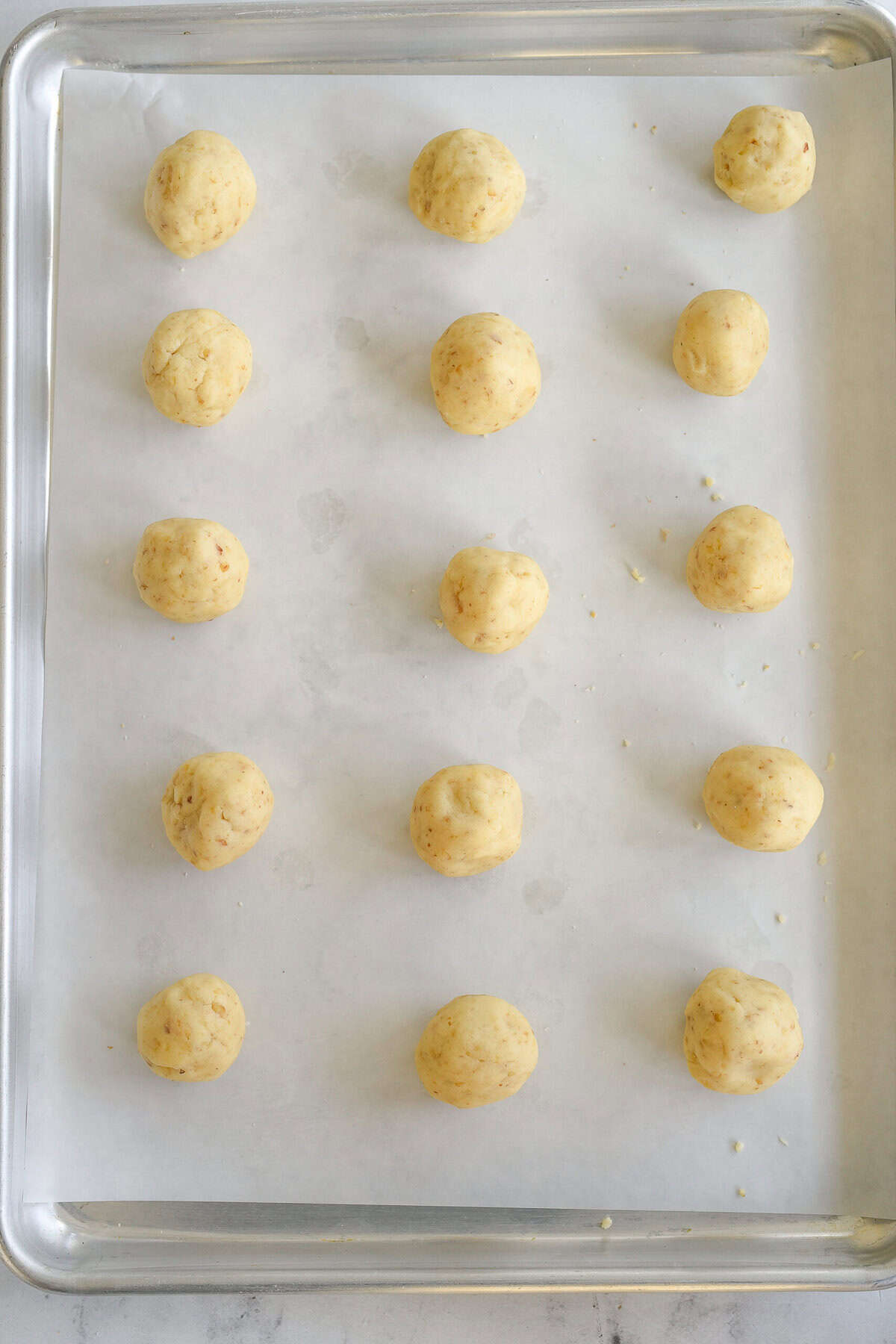 cookie sheet with dough balls on it