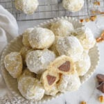 overehad shot of snowball cookies with one cookie cur in half