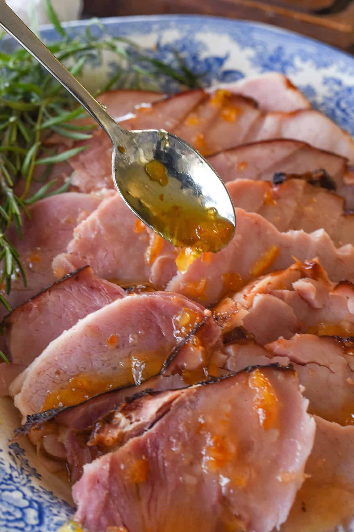 adding citrus glaze to grilled ham