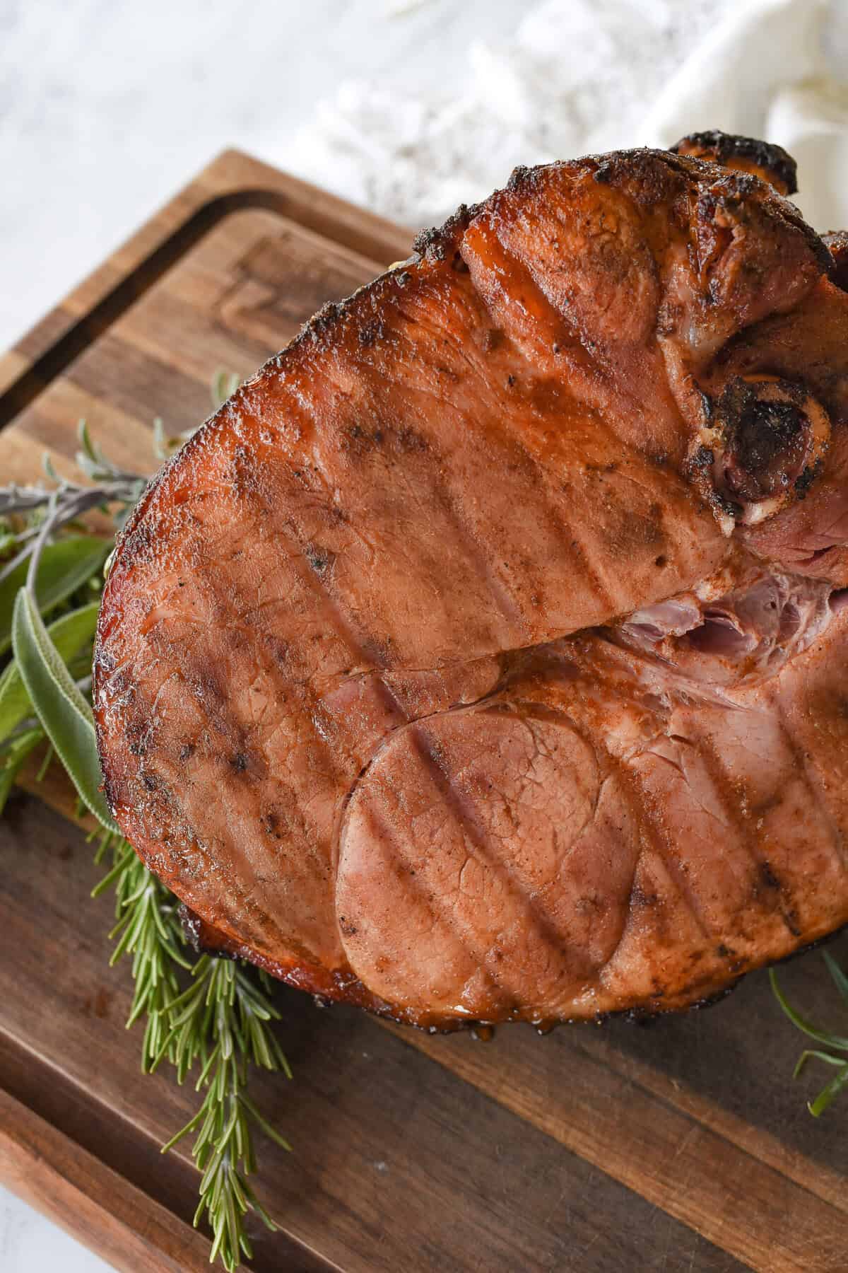 grilled ham resting on a cutrting board