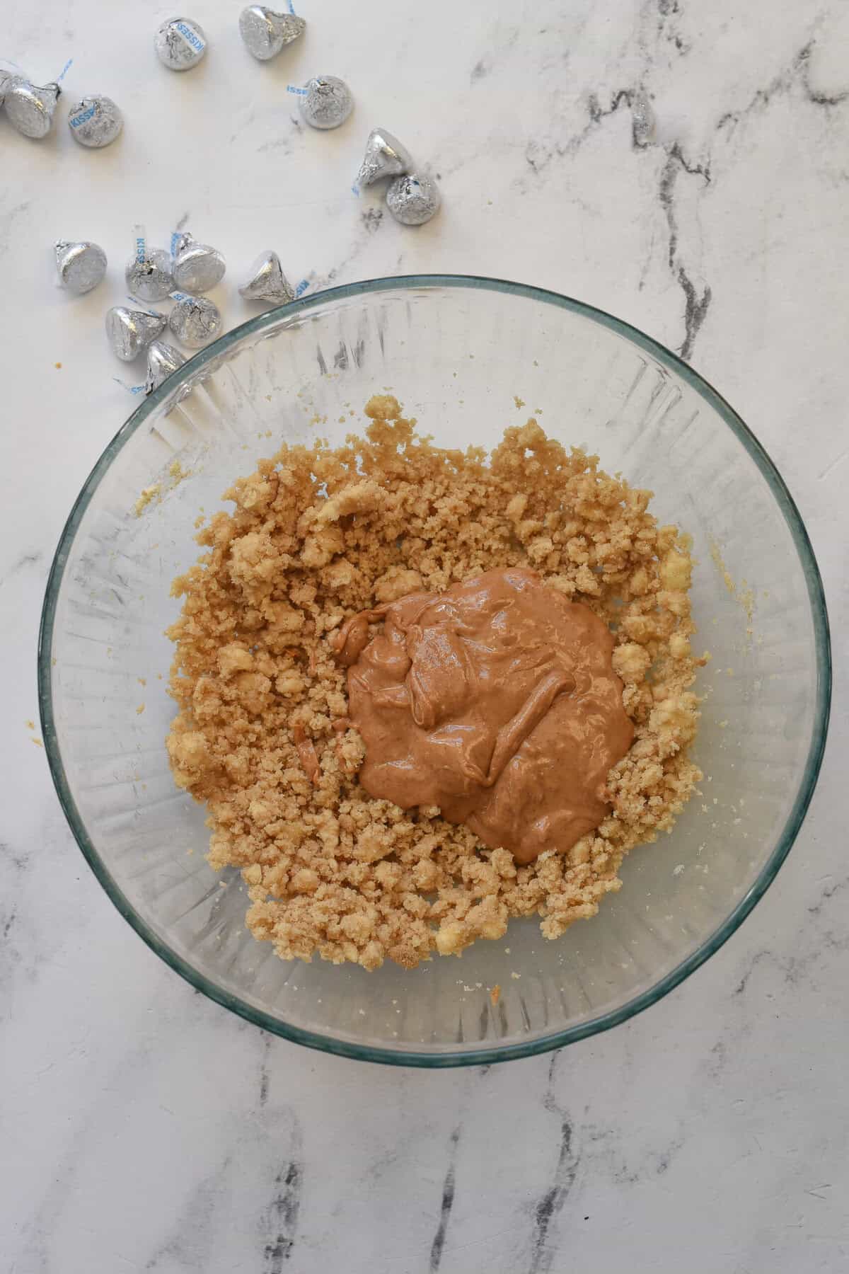adding peanut butter to cookie dough