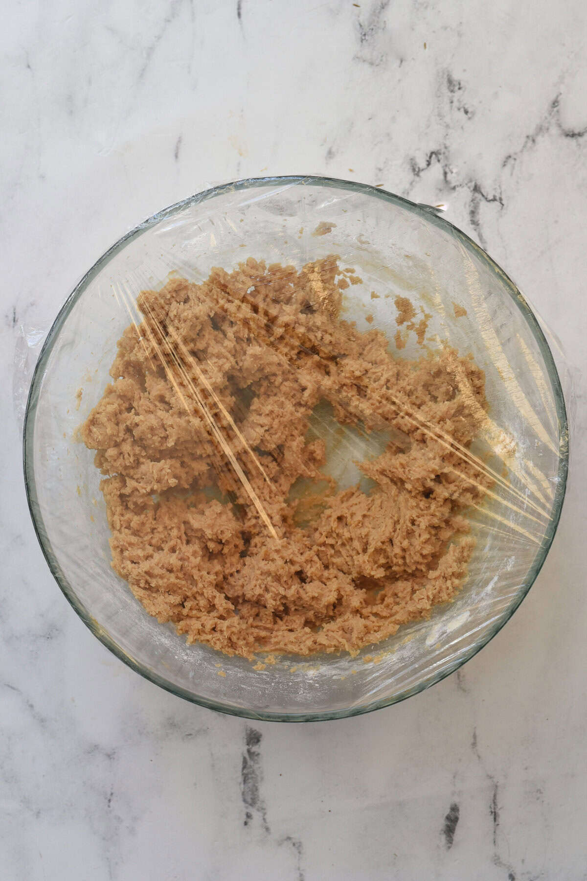 dough covered with plastic wrap to chill