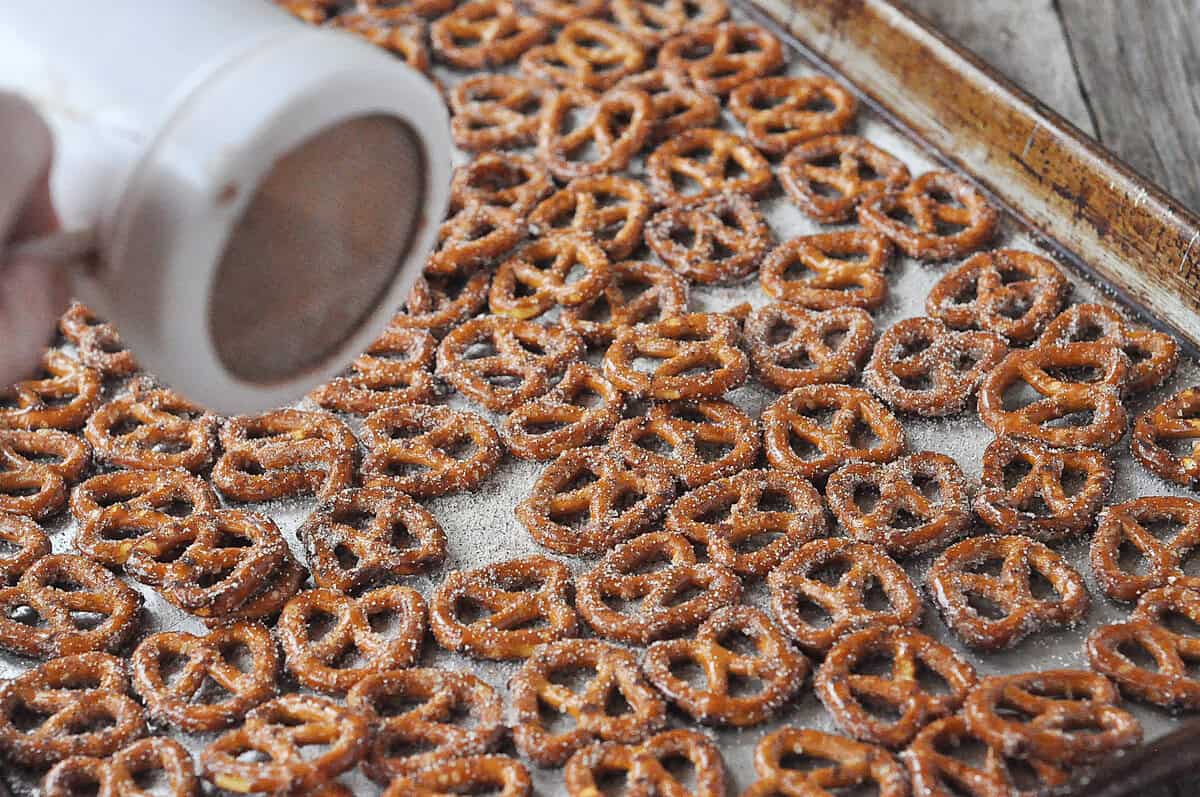 sprinkling pretzels with cinnamon sugar