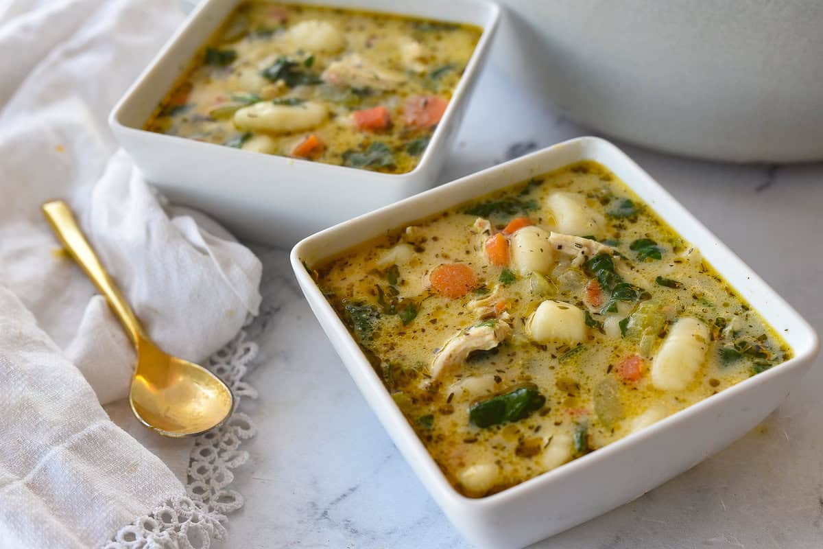 two bowls full of chicken gnocchi soup