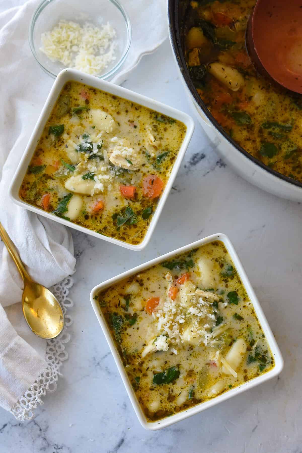 overhead shot of two bowls of chicken gnocchi soup