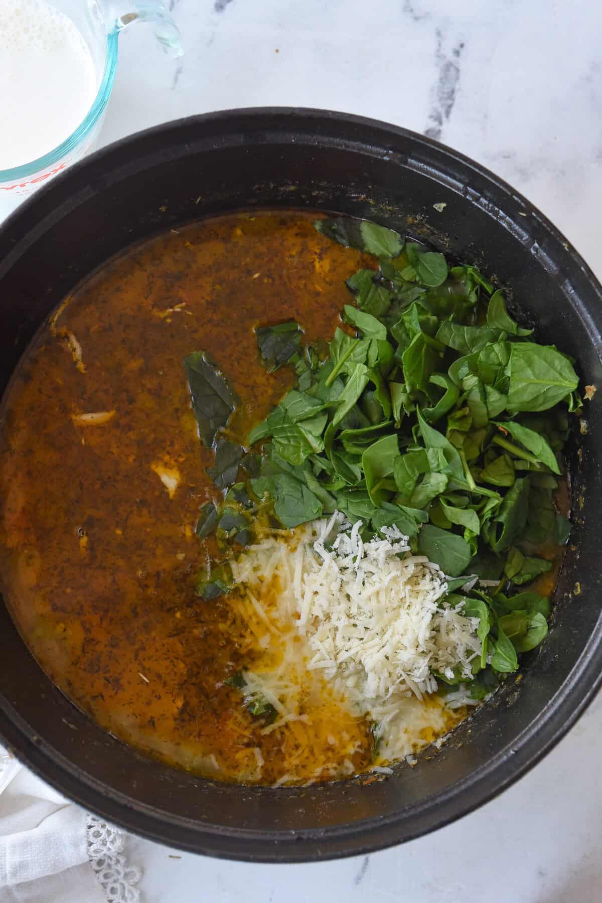 adding in spinanch and cheese to soup