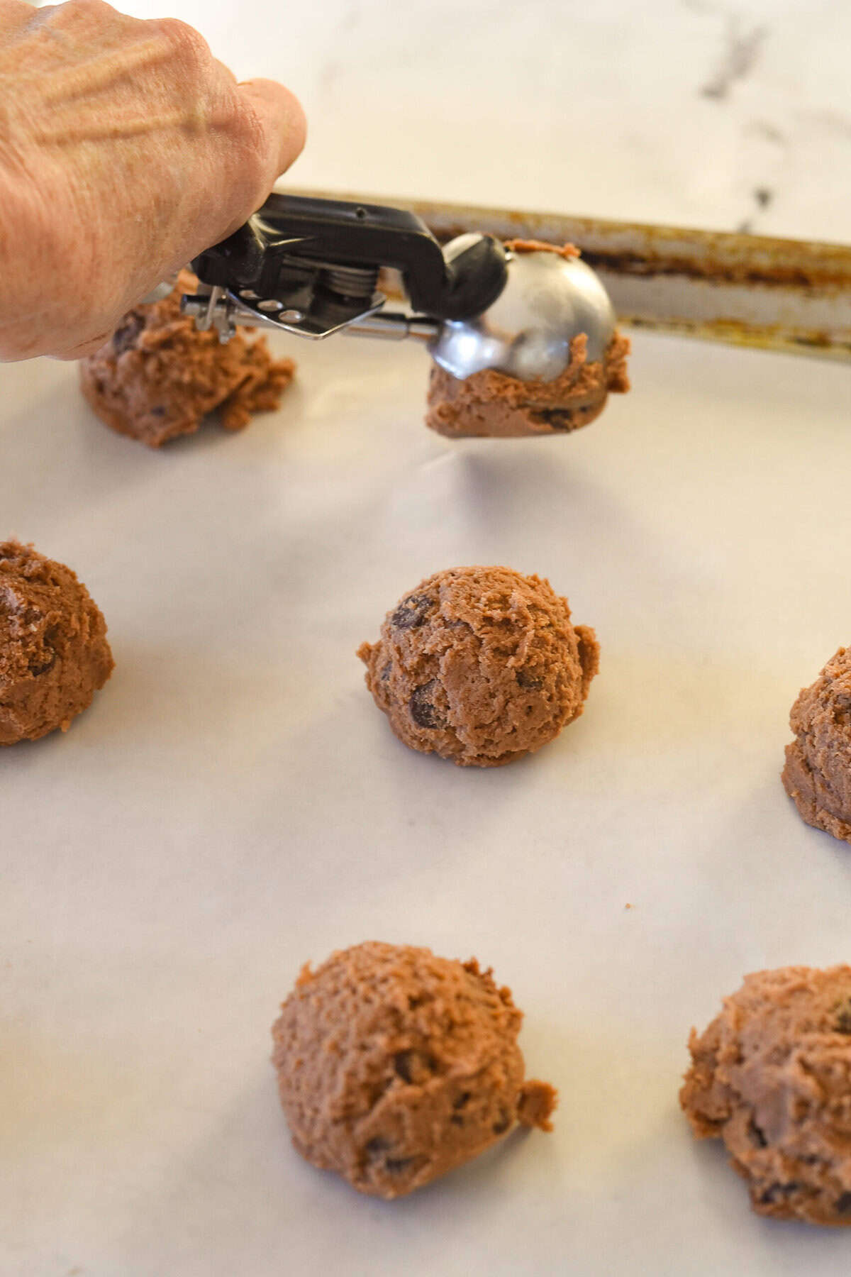 scooping cookie dough onto pan