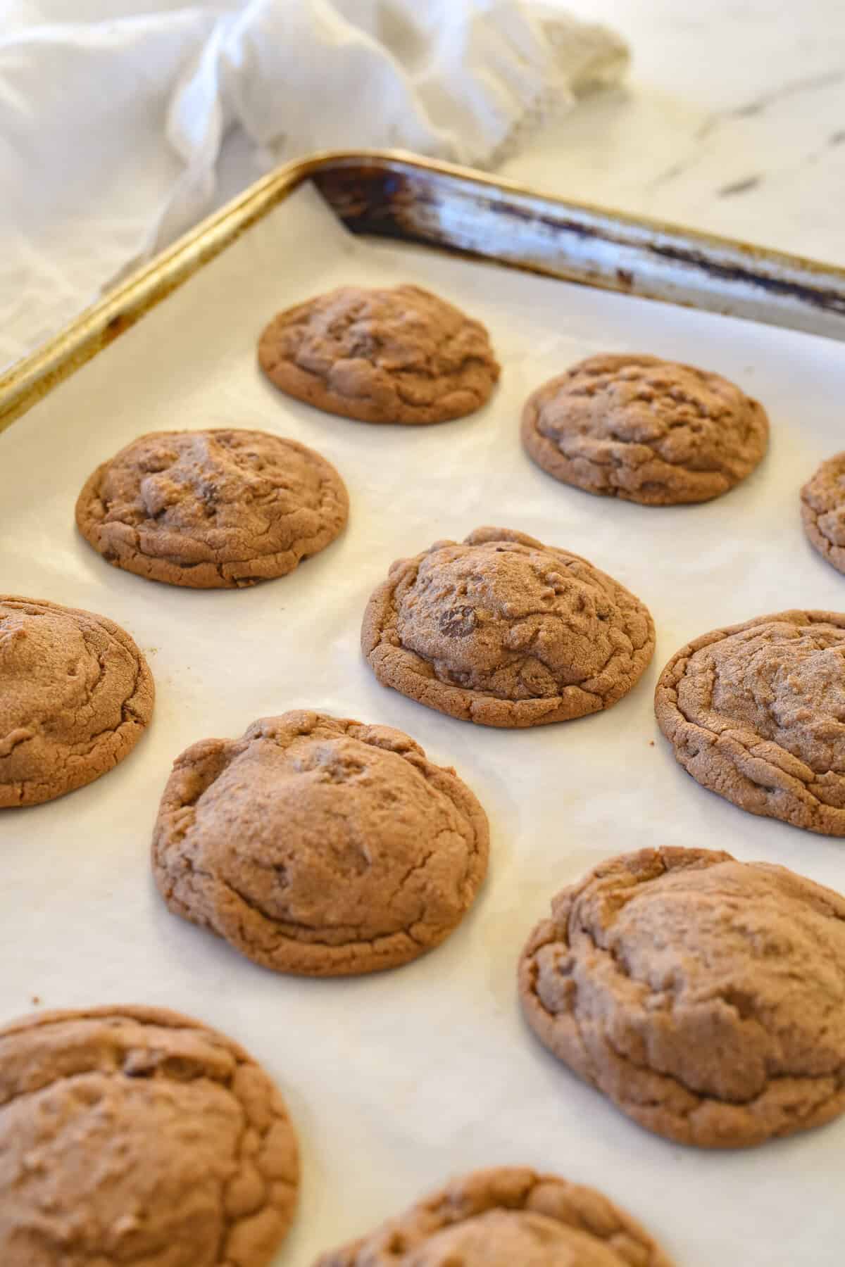 Nutella chocolate chip cookies cooling on a cookie sheet