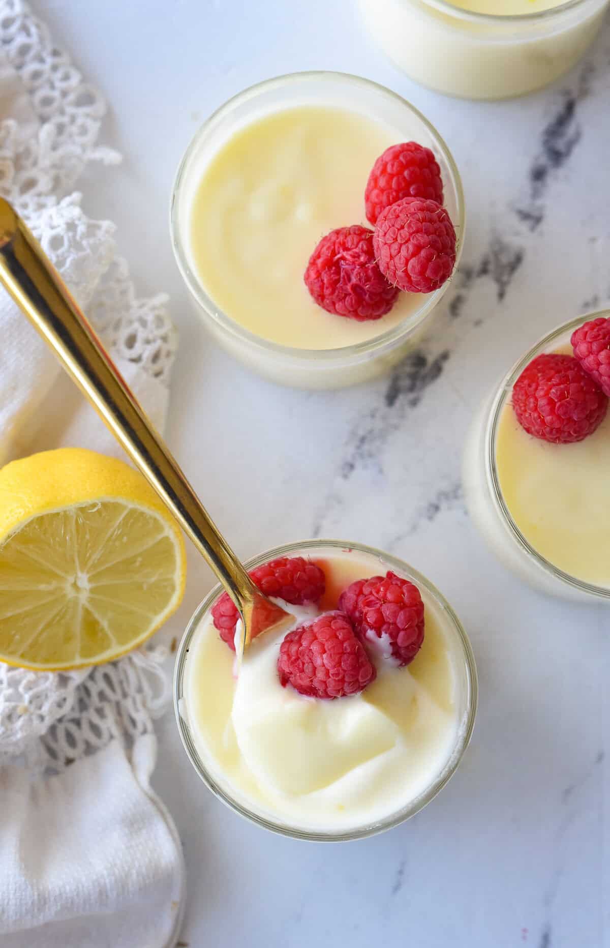 overhead shot of lemon posset, spoon in one of the bowls