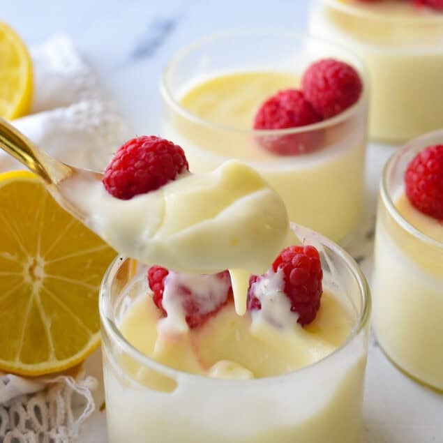 spoon ful of lemon posett and and raspberries on it