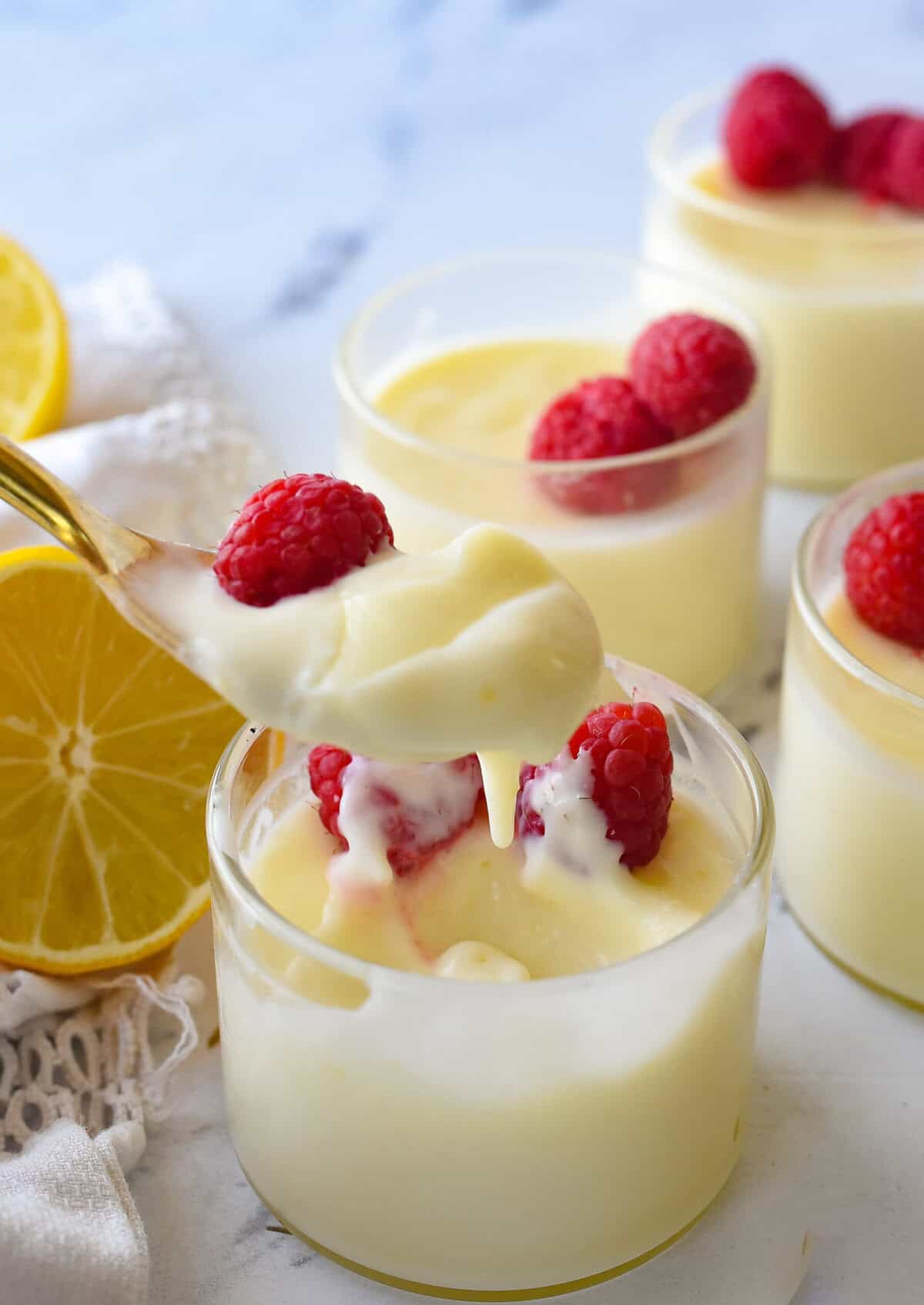 spoon ful of lemon posett and and raspberries on it