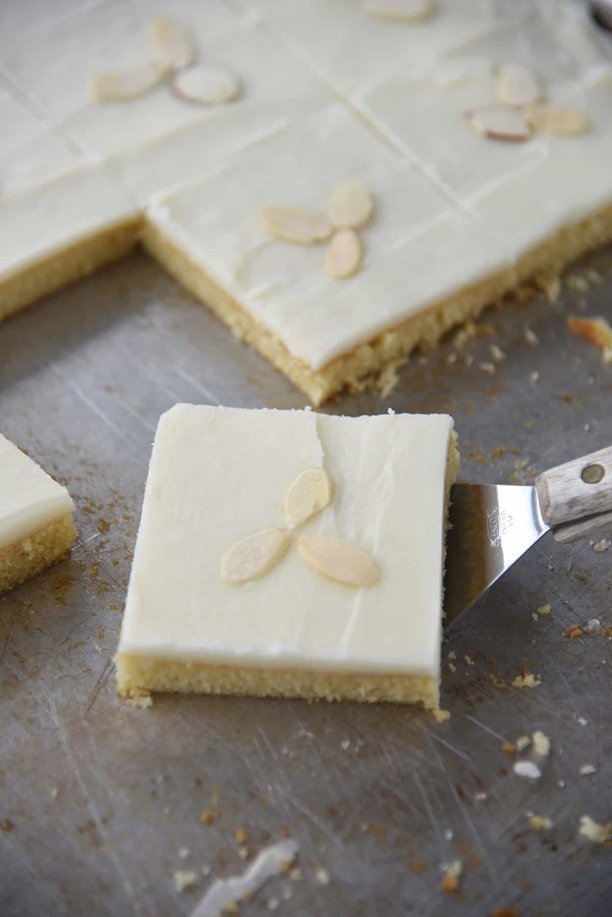 white texas sheet cake recipe piece of white texas sheet cake on a spatula