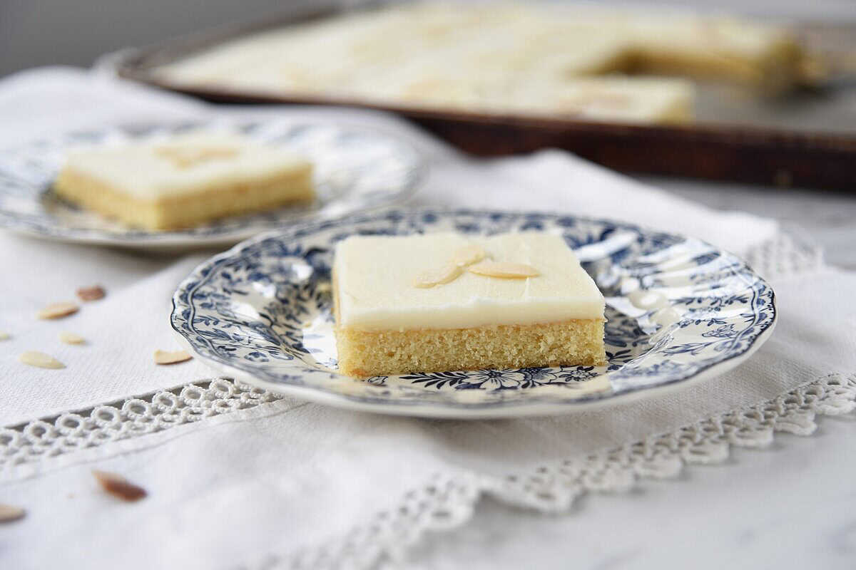 slice of almond sheet cake white texas sheet cake on plates, 2 pieces