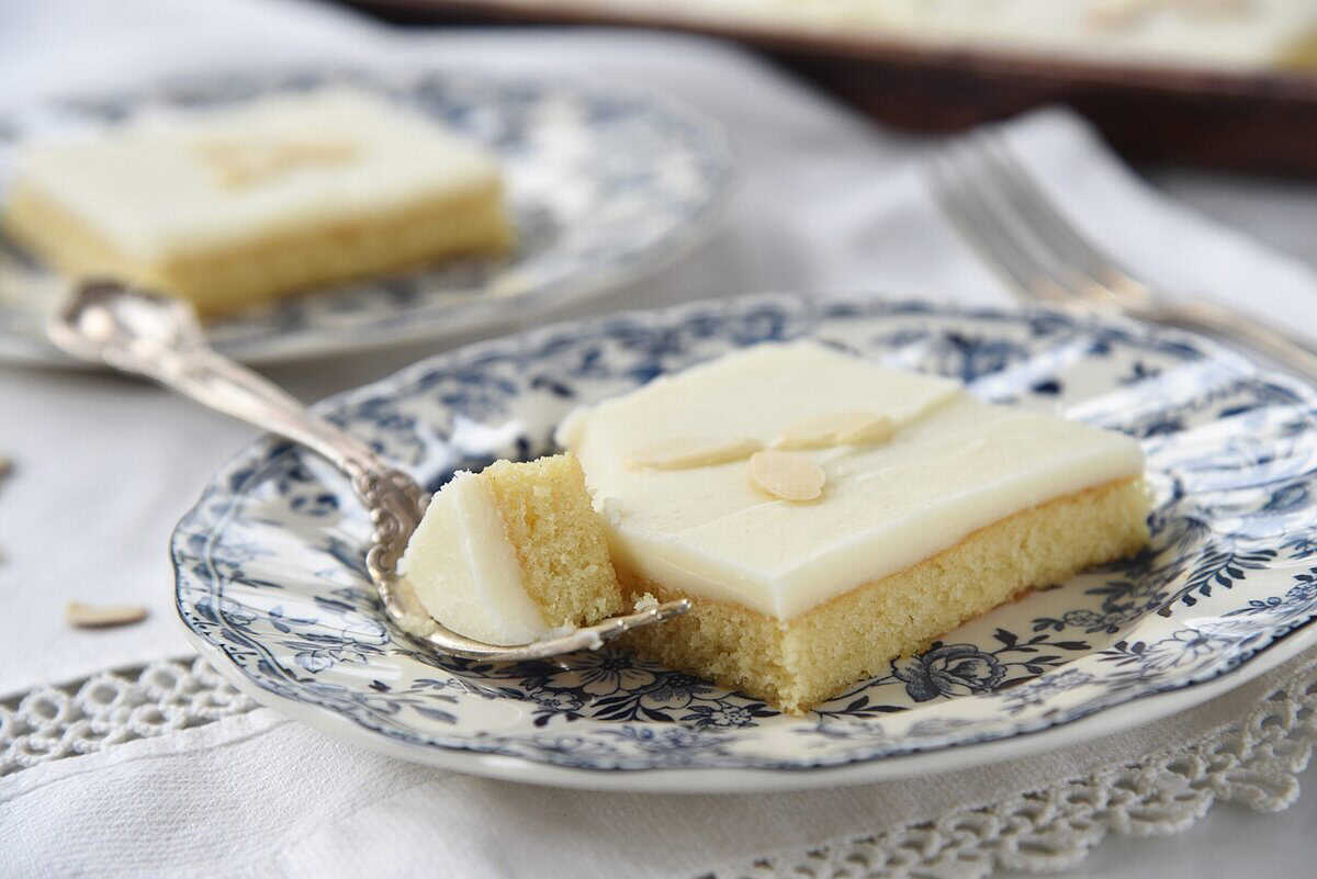 piece of white texas sheet cake on a plate with a fork