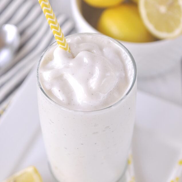 tall glas of frosted lemonade with a straw
