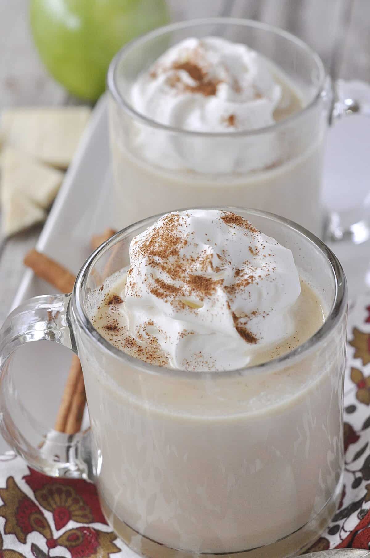 overhead shot of two mugs of apple cider hot chocolate