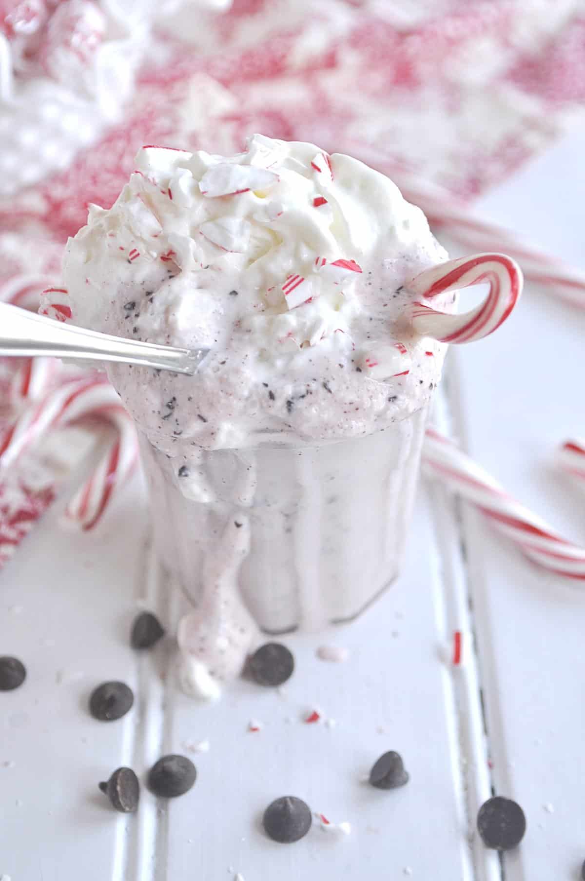 spoon in a glass of peppermint milkshake
