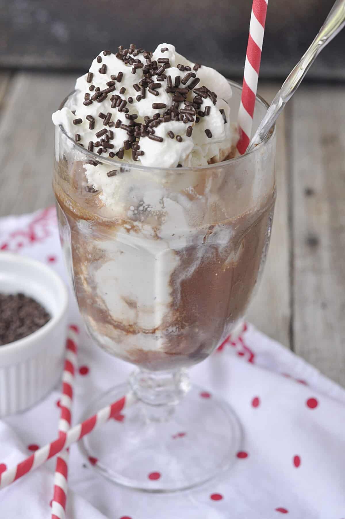 topping soda with whipped cream and sprinkles