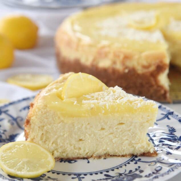 slice of lemon white chocolate cheesecake on blue and white plate