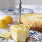 fork in a slice of lemon white chocolate cheesecake