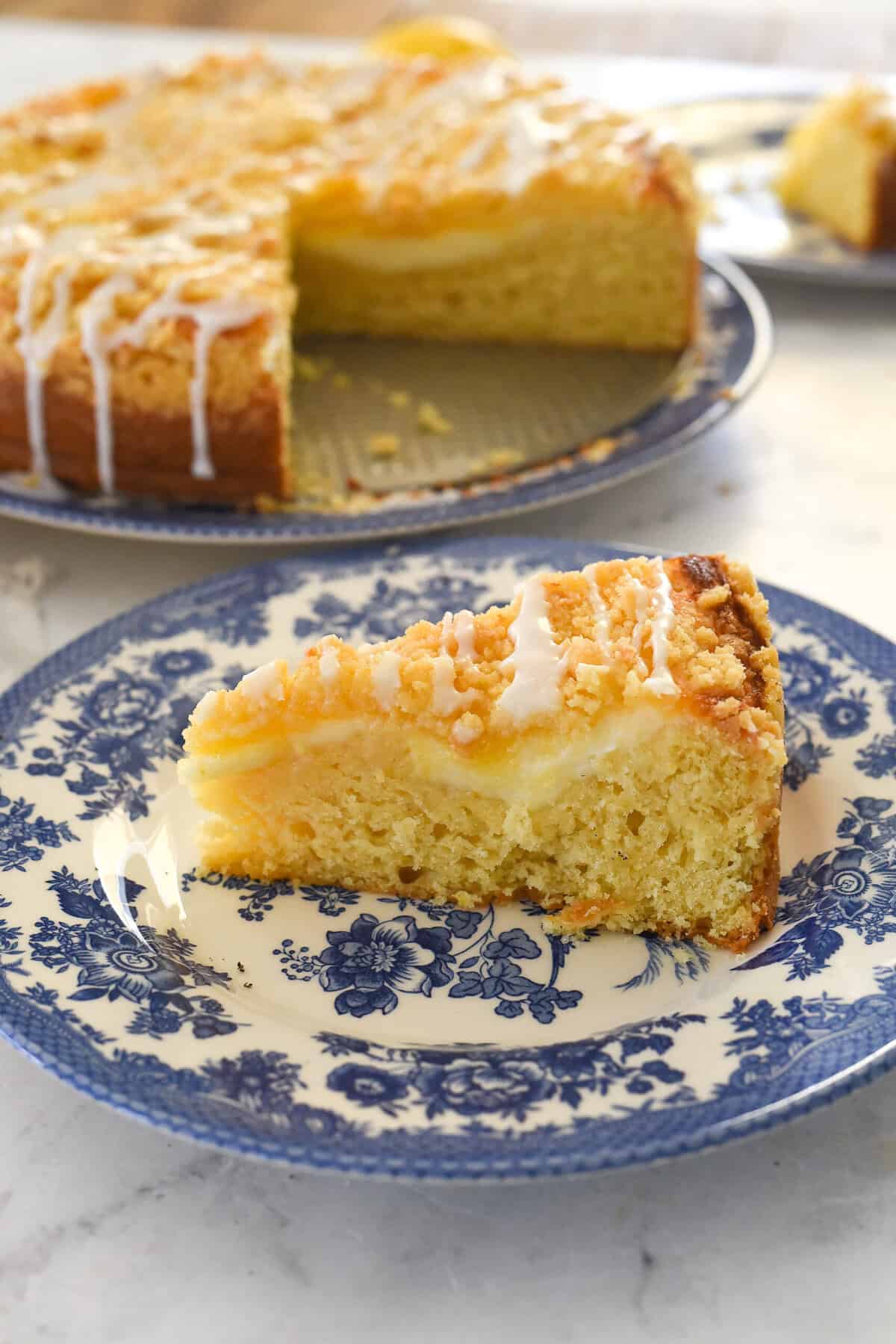 slice of lemon cream cheese coffee cake on a blue and white plate