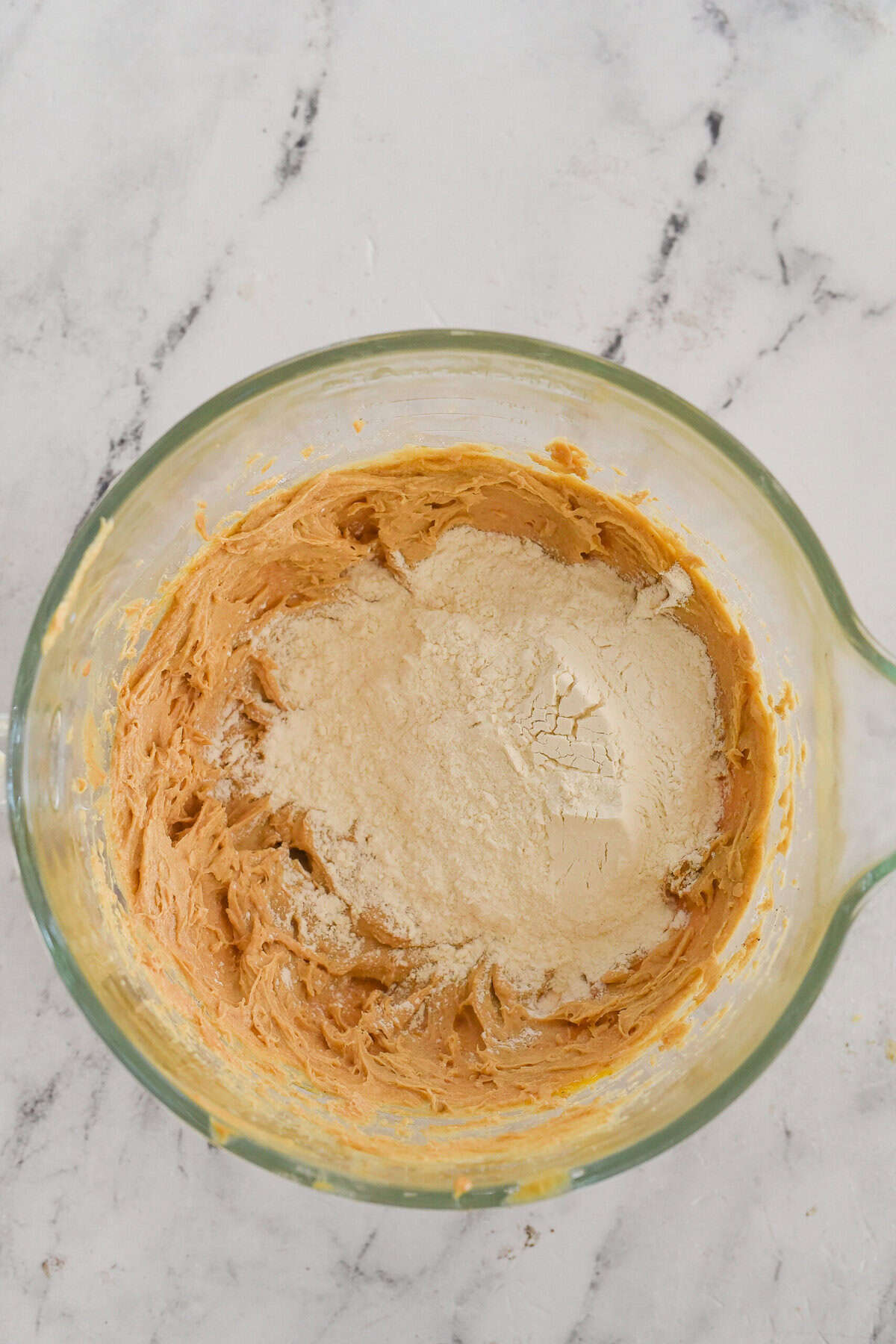 adding dry ingredients to cookie dough