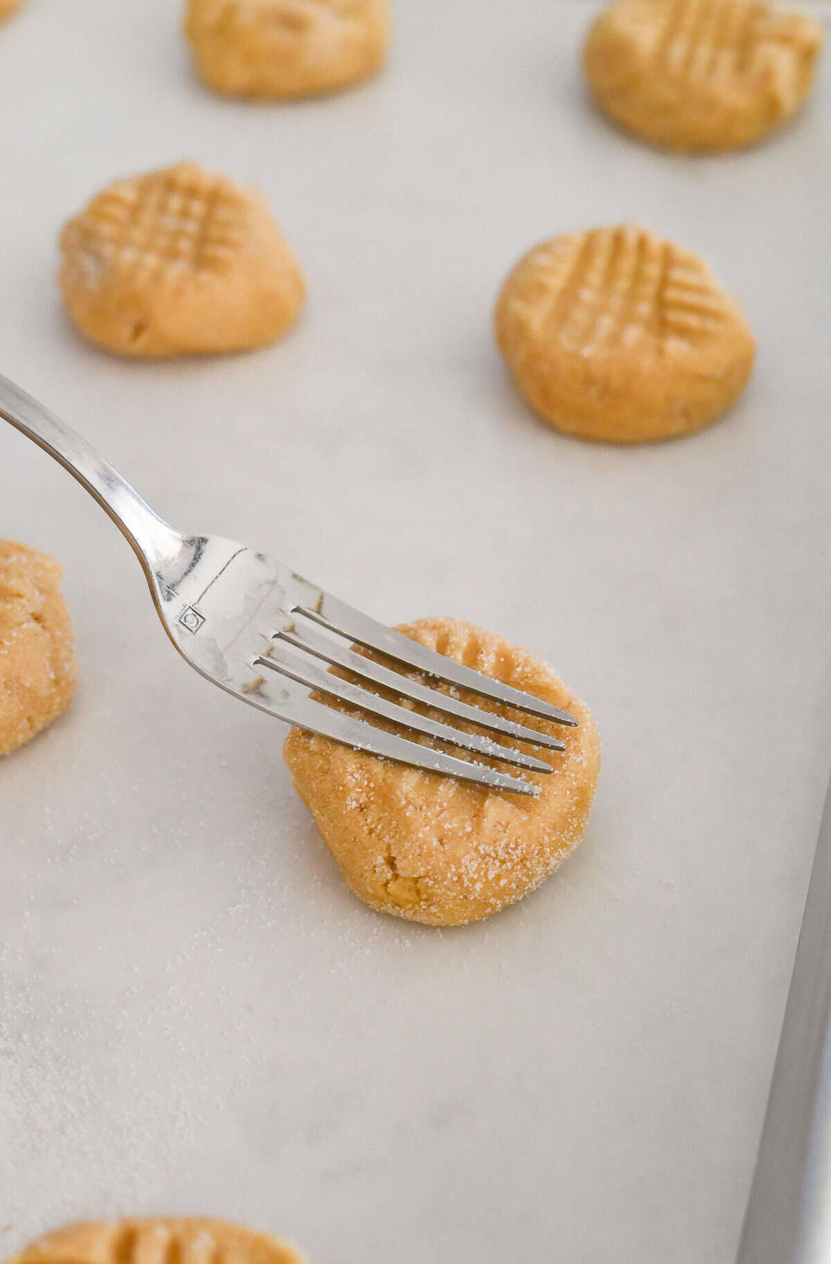 pressing peanut butter cookie dough down with a fork