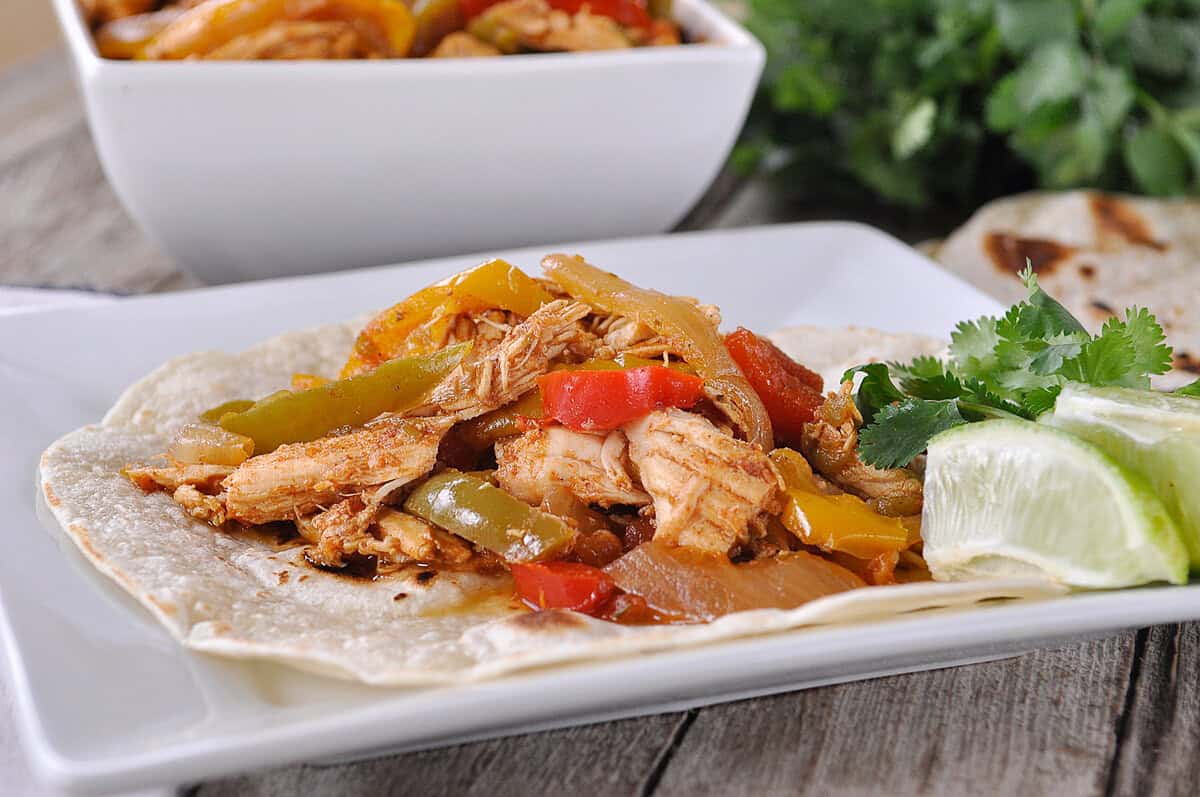 slow cooker chicken fajita on a tortilla