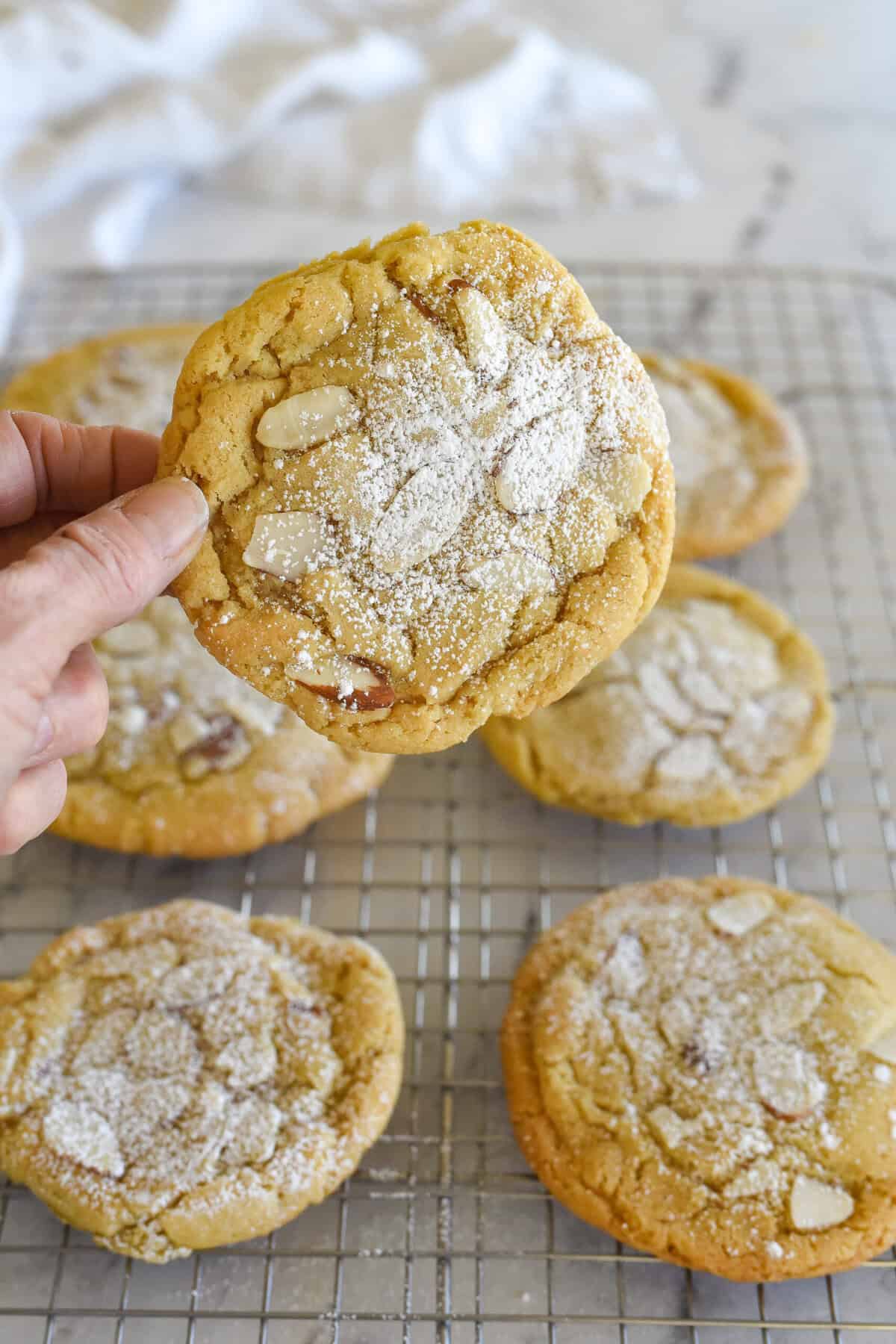 hand holding an almond croissant cookie