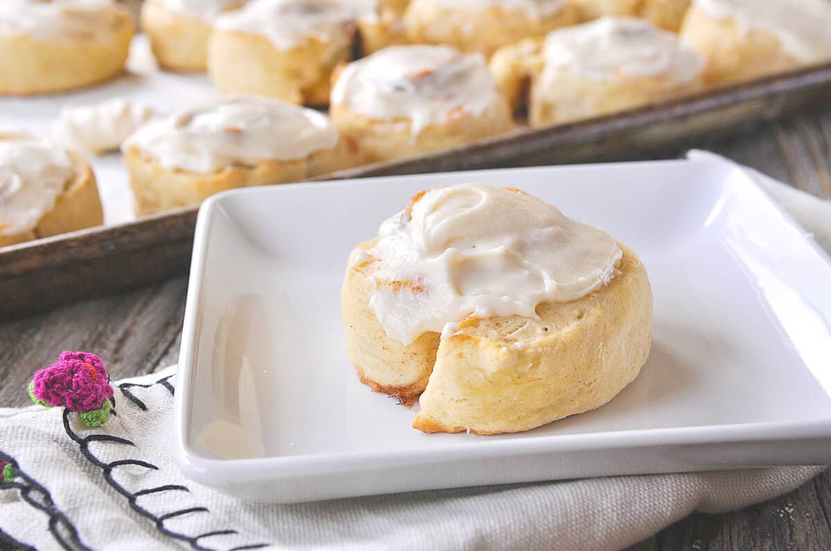 a frosted biscuit cinnamon roll on a plate