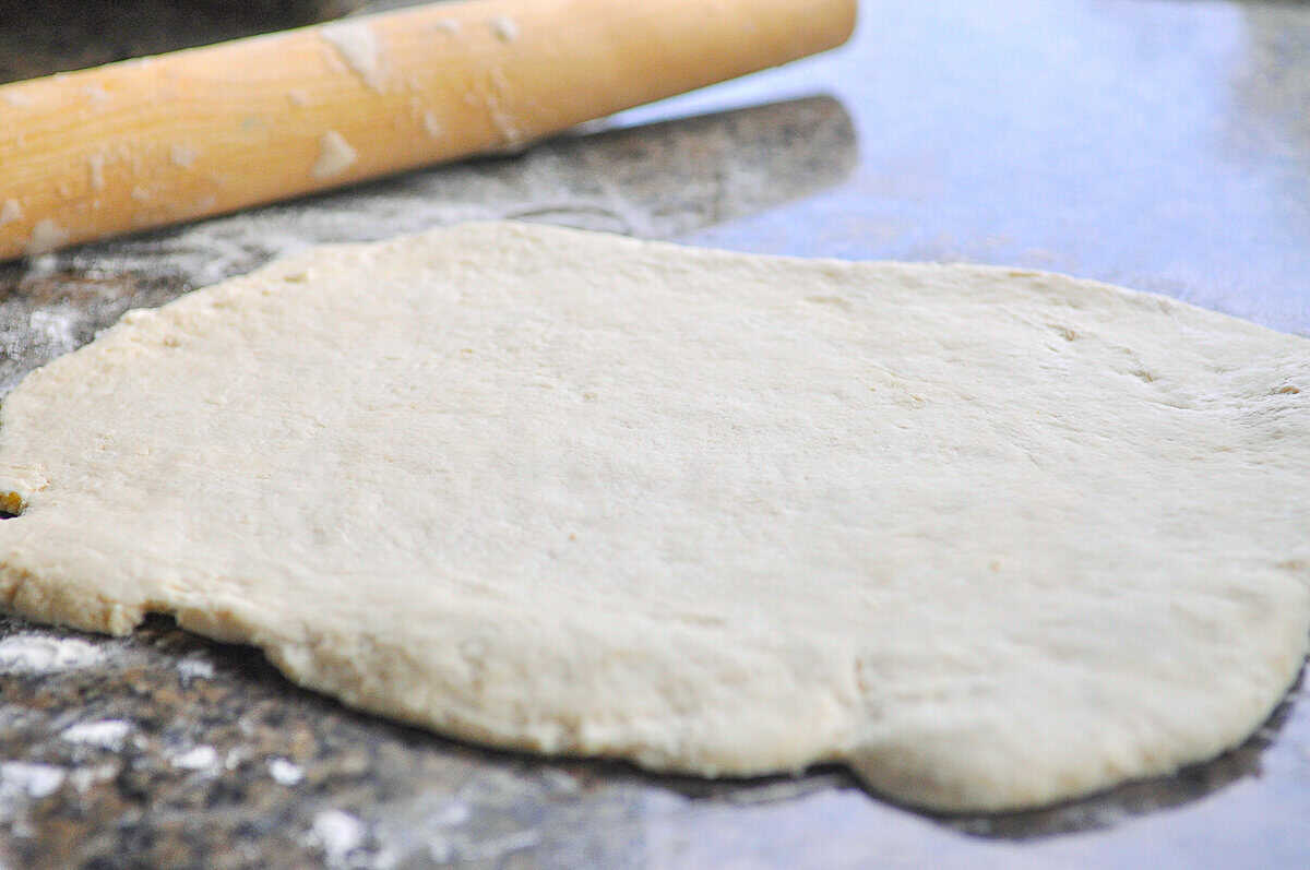 biscuit dough rolled out on counter