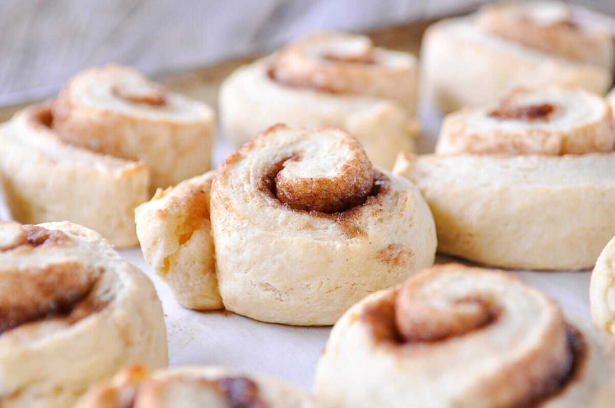 baked cinnamon rolls on a cookie sheet