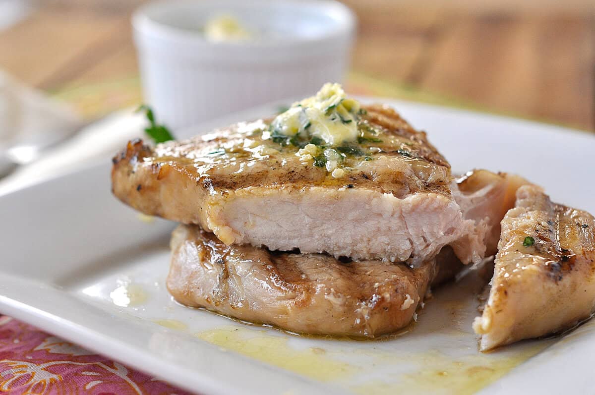 grilled pork chops cut open brined grilled pork chop on a plate