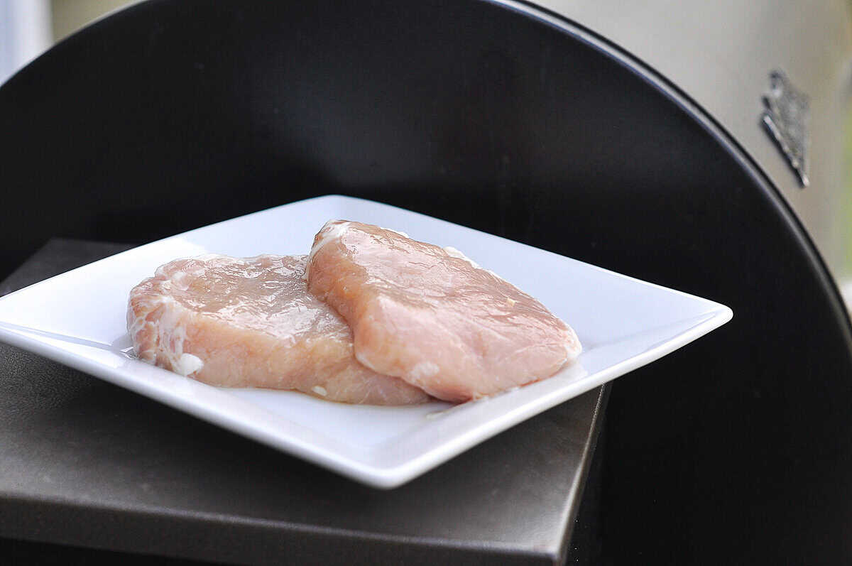 pork brine two brined pork chops on a white plate