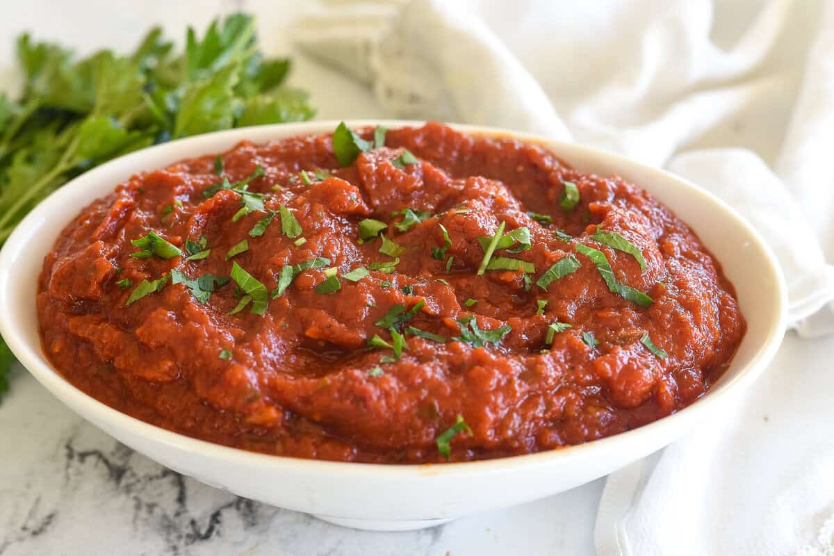 white bowl full of marinara sauce