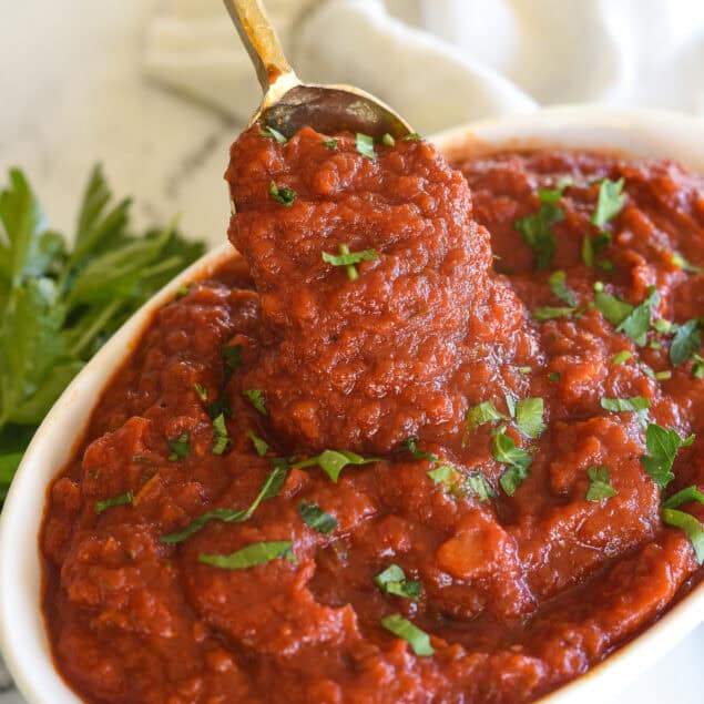 spoonful of marinara sauce in a white bowl