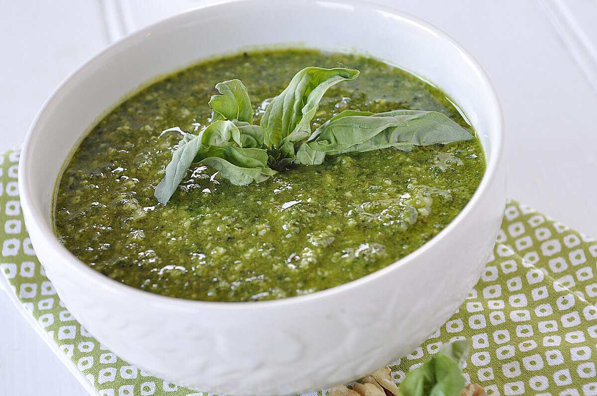 pesto bowl of pesto with basil leaves on top