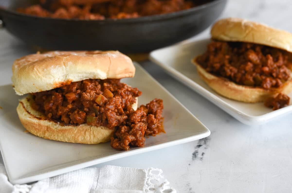 picture of two sloppy joes sandwiches on white plates