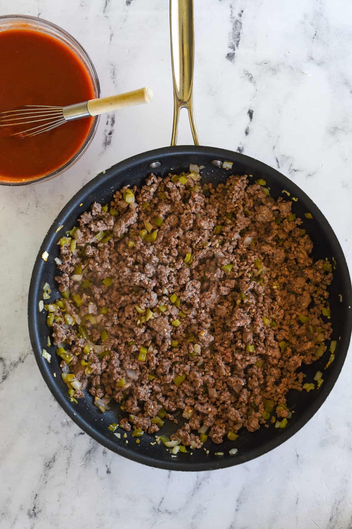 browned hamburger in frying pan