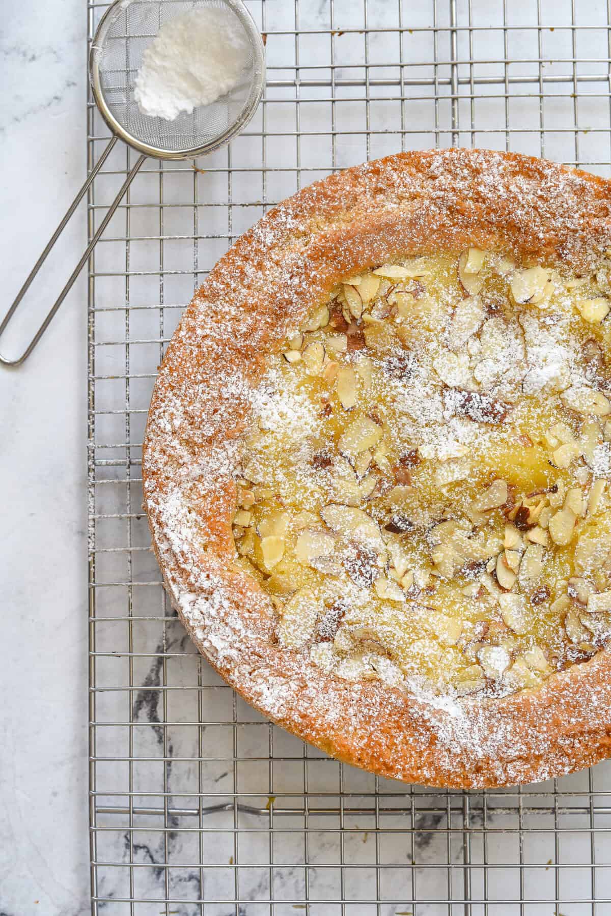 lemon almond butter cake sprinkled with powdered sugar
