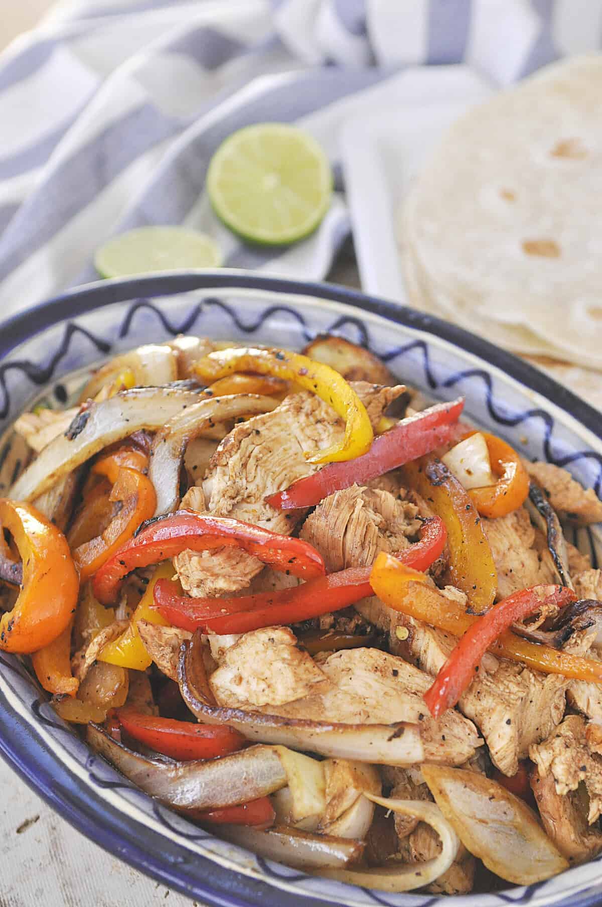chicken fajitas sliced chicken and peppers in a bowl