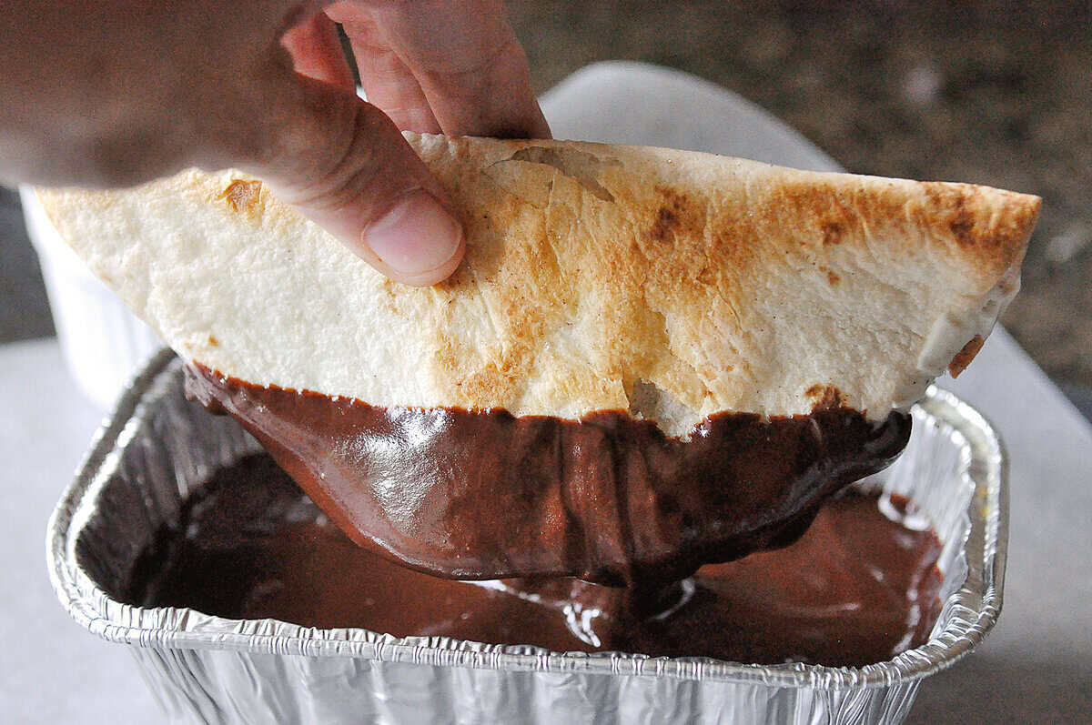 dipping ice cream taco in chocolate