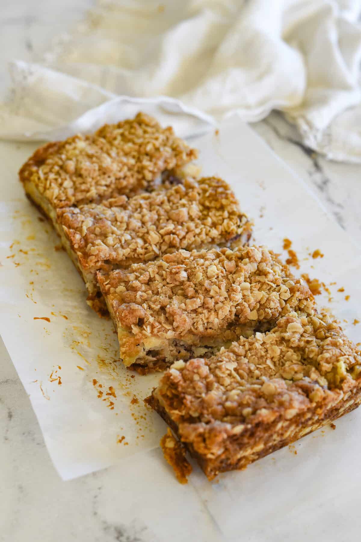 four sliced sour cream apple bars