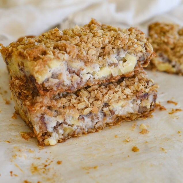 two sour cream apple bars stacked on top of eac other