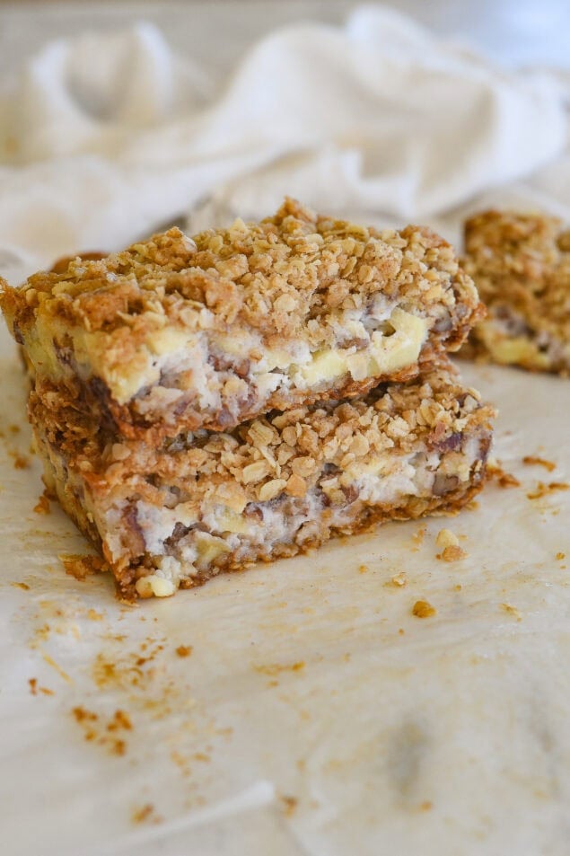 two sour cream apple bars stacked on top of eac other